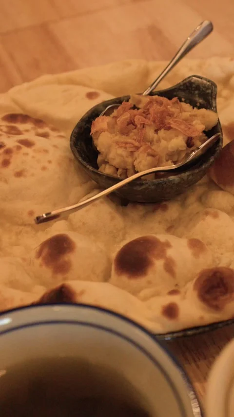 Fresh Naan Flatbread Served with Traditional Dip on Wooden Table Stock Footage 345220827