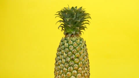 Fresh nutritional pineapple rotating / spinning against a colorful background Stock Footage 154153196