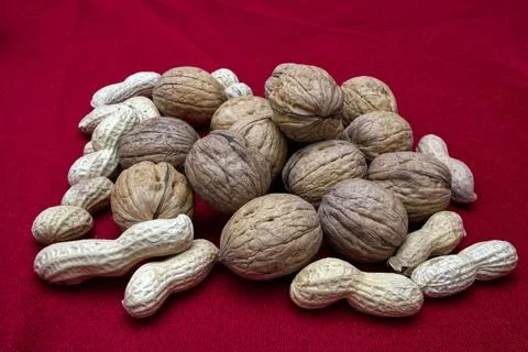 Fresh nuts and peanuts on red background Stock Photos