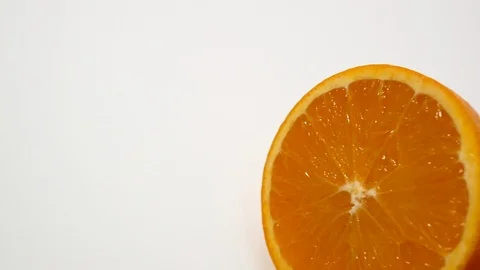 Fresh orange cut in half on white close up slider shot Stock Footage 99259941