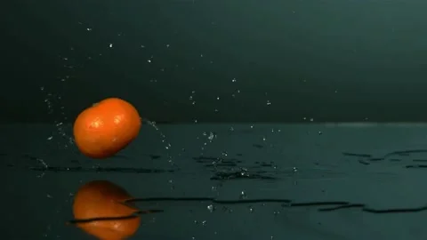 Fresh orange falling on wet surface with water splash Stock Footage 327514454