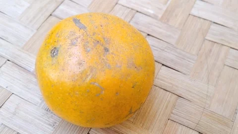 Fresh Orange Fruit Placed on a Natural Woven Bamboo Mat Background Stock Footage 340461918