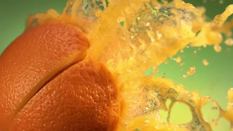 Fresh Orange fruit squirting with juice in slow motion in green nature Stock Footage 199130341