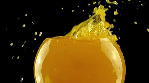 Fresh Orange Juice Splash with Fruit Slice in Glass Video stock 334320669