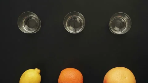 Fresh orange lemon grapefruit is Squeezed Into a Glass. Stop Motion Animation Stock Footage 87827288
