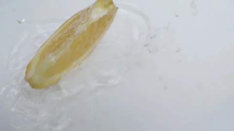 Fresh orange slice falling into water Stock Footage 63441191