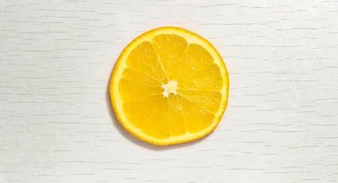 Fresh orange slice in the shape of a circle on a white background. Stock-Fotos