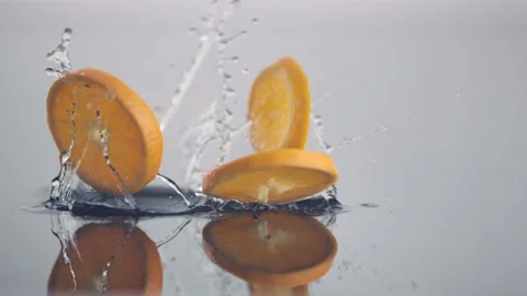 Fresh orange slices in circle shape fall down in slow motion Stock Footage 147231647