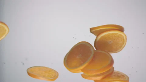 Fresh orange slices passing over in front of the camera in slow motion Stock Footage 147232184