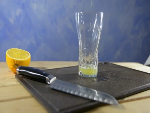 Fresh orange squeezed into a glass. macro Stock-Footage 121665286