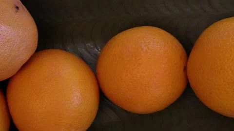 Fresh Oranges and Red Grapefruit in a Decorative Fruit Bowl on Kitchen Table Stock Footage 328451400