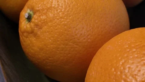Fresh Oranges and Red Grapefruit in a Decorative Fruit Bowl on Kitchen Table Stock Footage 328451482