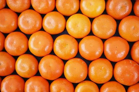 Fresh oranges arranged in a neat pattern on a table Stock Photos