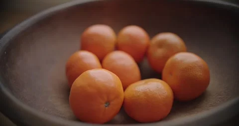 Fresh Oranges Arrayed Beautifully in Rustic Wooden Bowl Display Stock Footage 299716096