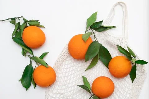 Fresh oranges on a mesh bag. Zero waste shopping bag Stock Photos