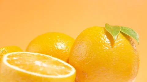 Fresh Oranges on orange background motion shot Stock Footage 244906029