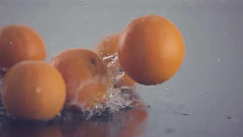 Fresh oranges pass in front of the camera in slow motion Stock Footage 147233420