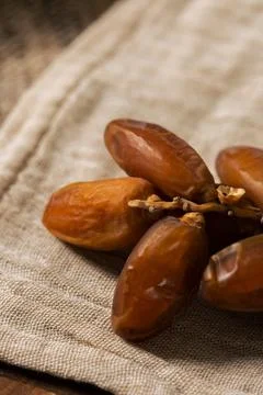 Fresh Organic Dates on Rustic Fabric Background Stock Photos