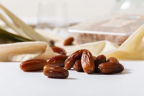 Fresh Organic Dates on White Surface with Blurred Background Stock Photos