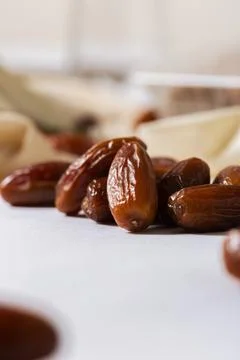 Fresh Organic Dates on White Surface with Blurred Background Stock Photos
