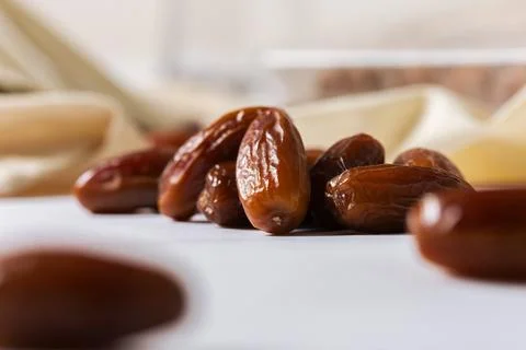 Fresh Organic Dates on White Surface with Blurred Background Stock Photos
