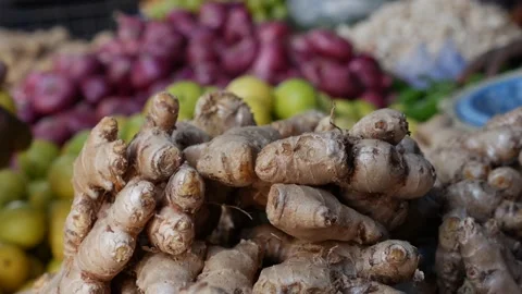 Fresh organic ginger root and other spices and vegetables for sale at vegetable Stock Footage 188450437