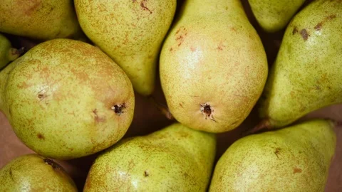 Fresh organic pears on rotating background. Top view. Vegan and raw food concept Stock Footage 125353917