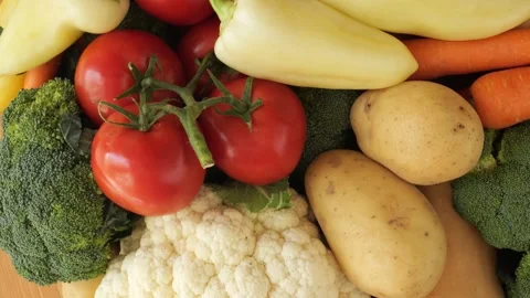 Fresh organic raw vegetables rotating on a table Stock Footage 340160202