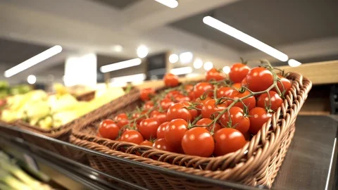 Fresh organic red cherry tomatoes on the supermarket shelf in basket for sale Stock Footage 129107485