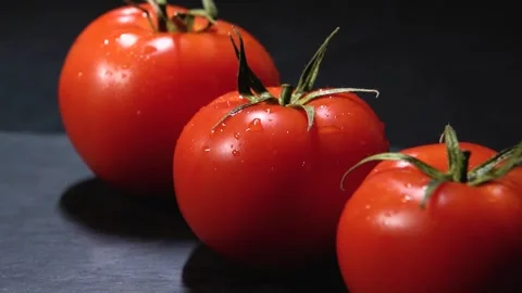 Fresh organic tomatoes on a dark background Stock Footage 240201800