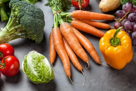 Fresh organic vegetables on rustic background Stock Photos