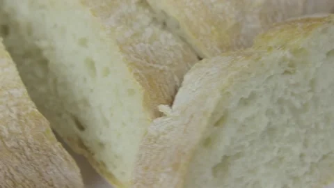 Fresh organic wheat bread rotates on a white background Stock Footage 131074394