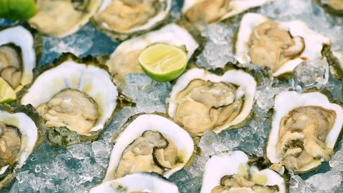 Fresh Oyster on half shell on big plate in restaurant Stock Footage 107271260