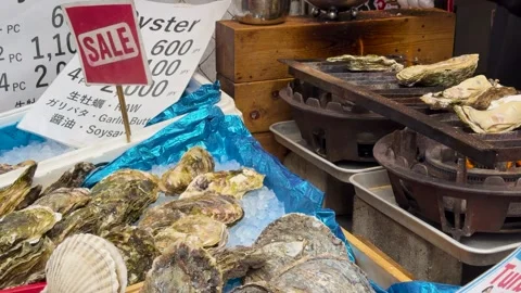 Fresh oysters being grilled at outdoor market stall. Stock Footage 333163353