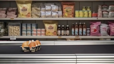 Fresh packaged eggs are riding the checkout line at the grocery store Stock Footage 238695106