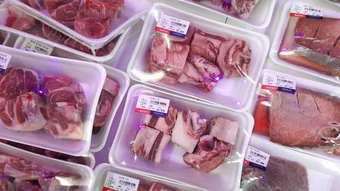 Fresh Packaged Raw Meat or Beef Cuts Displayed in a Supermarket Stock Photos