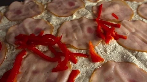 Fresh paprika slices falling on lavash flatbread with ham and cream Stock Footage 345186233
