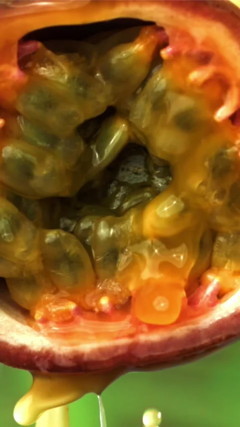 Fresh passion fruit with a splash of juice. Filmed on a high-speed camera at Stock Footage 335323771