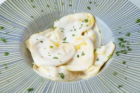 Fresh pasta filled with white cream sauce Stock Photos