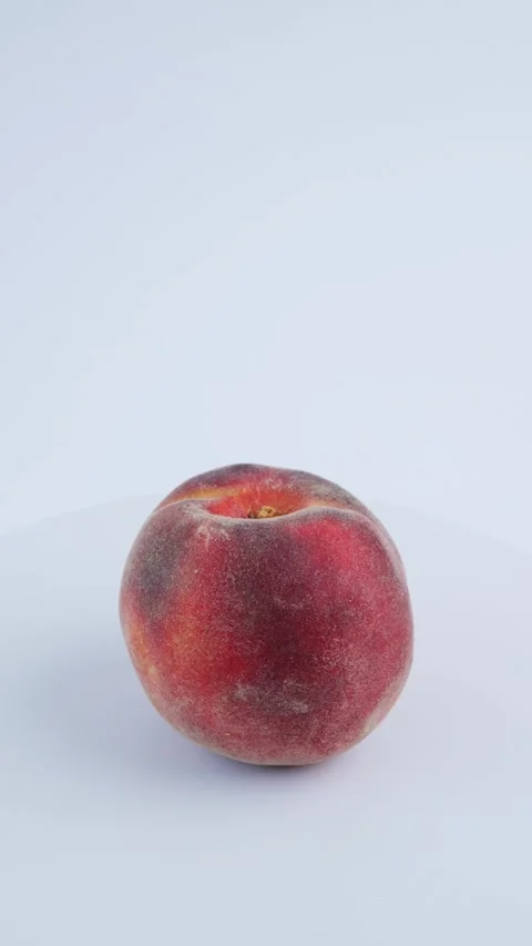Fresh peach rotates smoothly on white background, highlighting ripe produce. 4k Stock-Footage 342963964