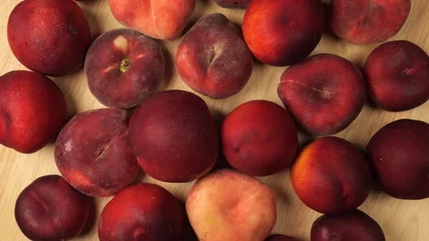 Fresh peaches and nectarines rotating on wood background Stock Footage 344604523