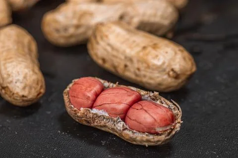Fresh peanuts in shell on black background close up Фото