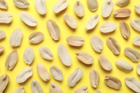 Fresh peanuts on yellow background, top view Stock Photos