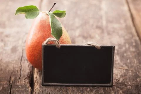 Fresh pear with a blank slate Stock Photos