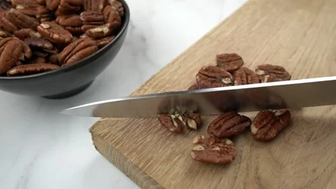 Fresh Pecan nuts being chopped on a wooden board. Slow Motion Chopping Stock Footage 150278061