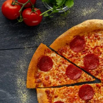 Fresh pepperoni pizza over a rustic background Stock Photos
