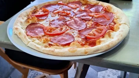 Fresh Pepperoni Pizza with Tomatoes Served Hot on Restaurant Table Stock Footage 338426557