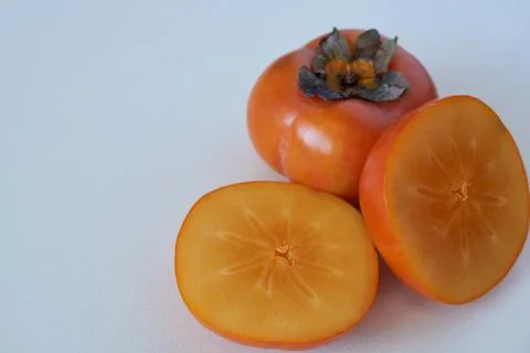 Fresh persimmon fruit on white background. Selective focus. Stock Photos