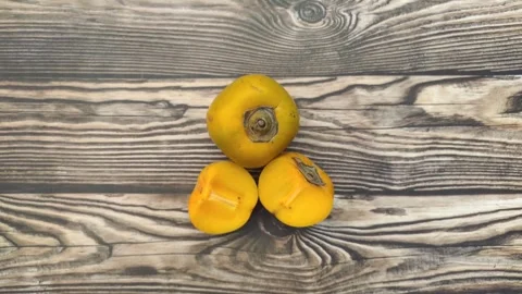 A Fresh Persimmon on A Wooden Table Stockbeeldmateriaal 337925309
