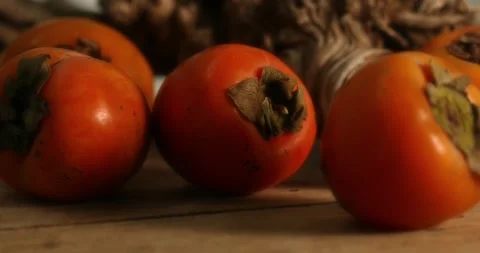Fresh Persimmons on Wooden Surface. Stock Footage 260341511